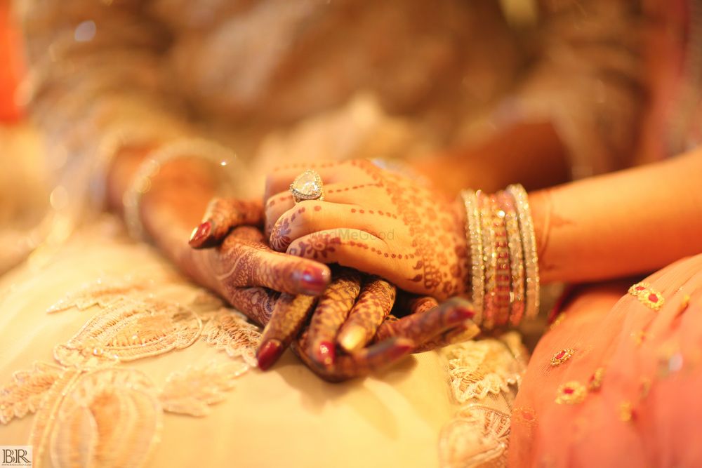 Photo of Bridal hands with mehendi and ring