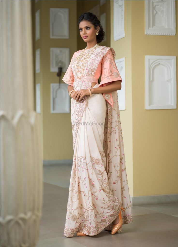 Photo of White saree with peach bell sleeved blouse