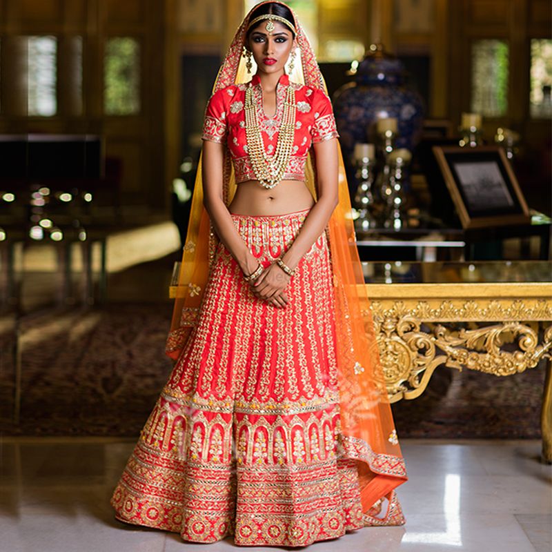 Photo of Bright red and orange bridal lehenga