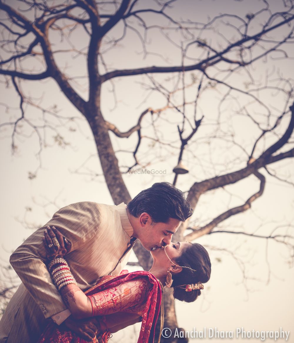 Photo of Romantic couple post wedding shot kissing