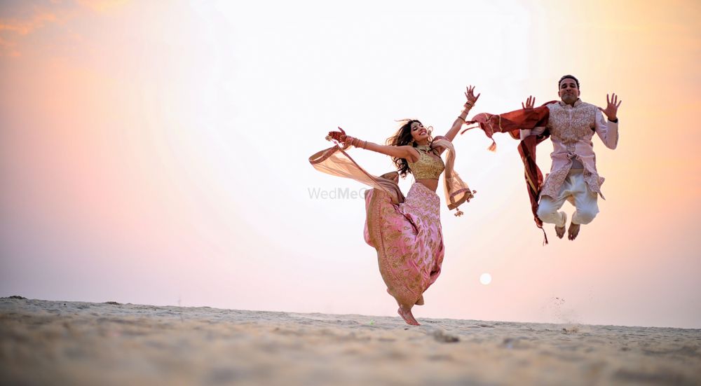 Photo of Crazy couple jumping shot after wedding