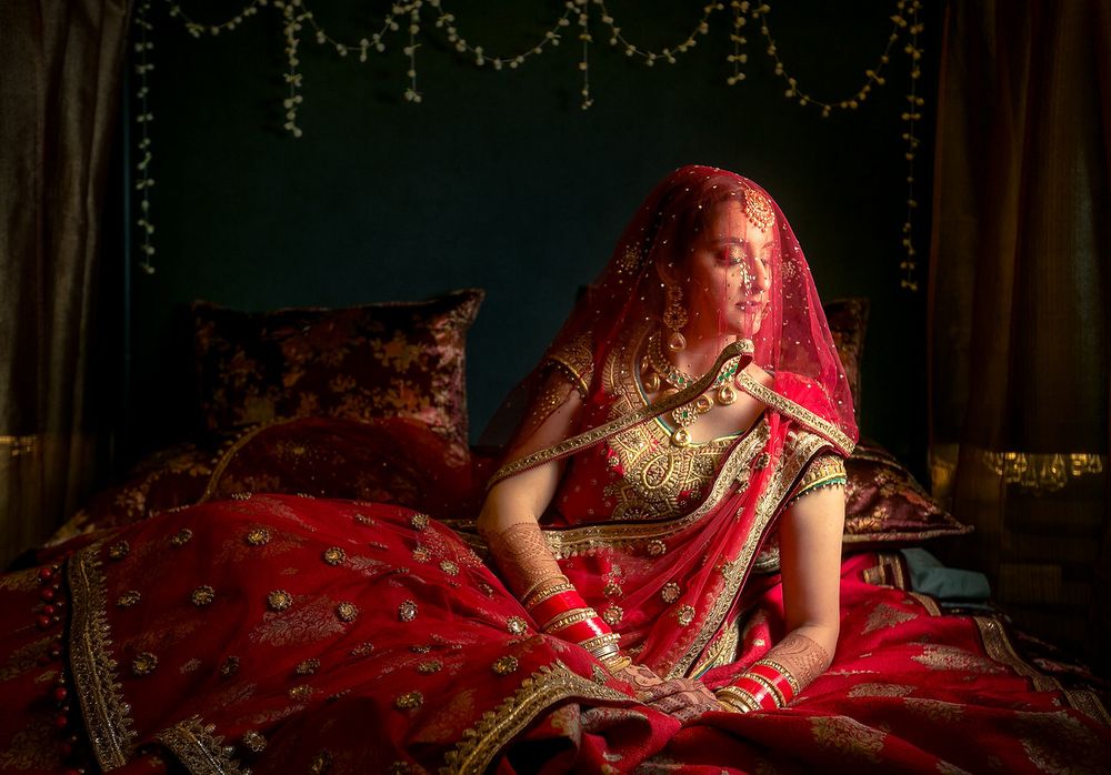 Photo of Bridal portrait in red with dupatta as veil