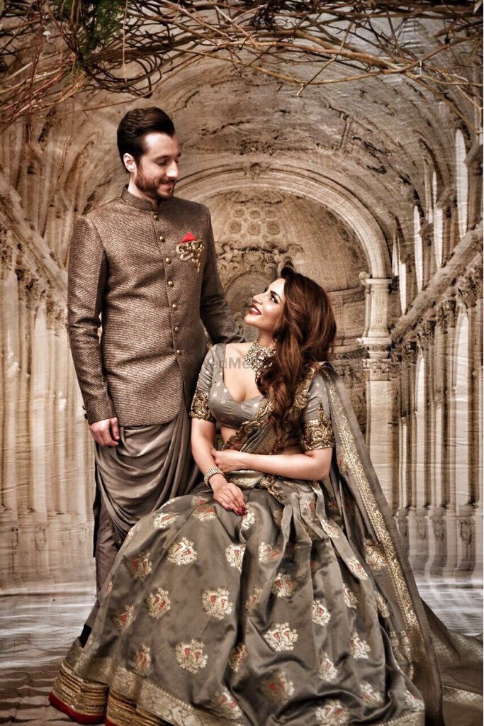 Photo of Dark grey outfits for bride and groom engagement and sangeet