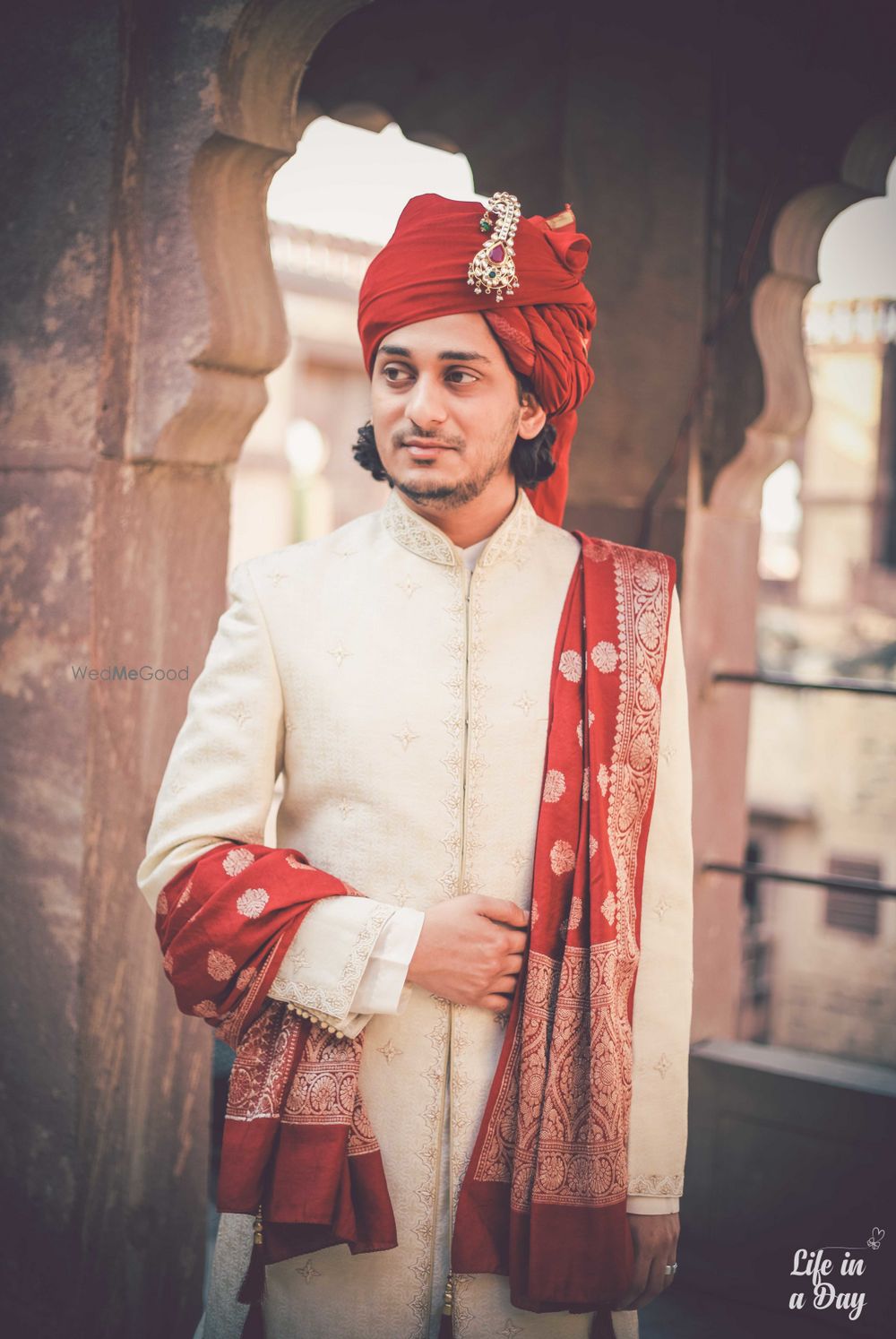 Photo of Off white sherwani with red safa and stole