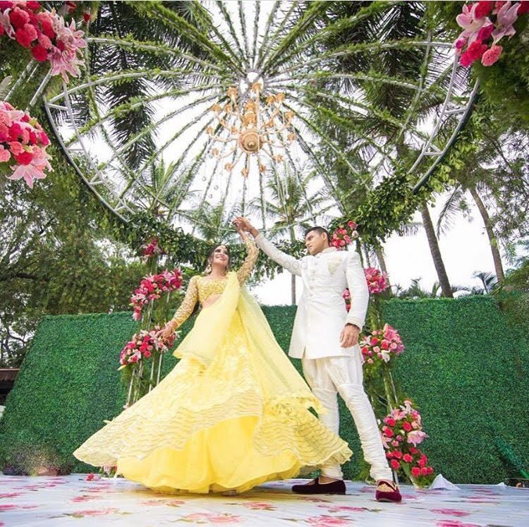 Photo of Twirling bride shot in pretty yellow lehenga
