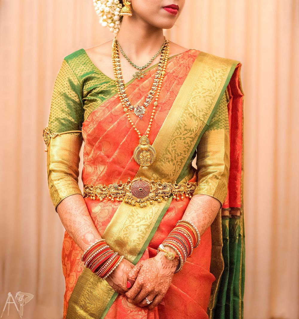 Photo of South Indian bridal jewellery with orange and green saree