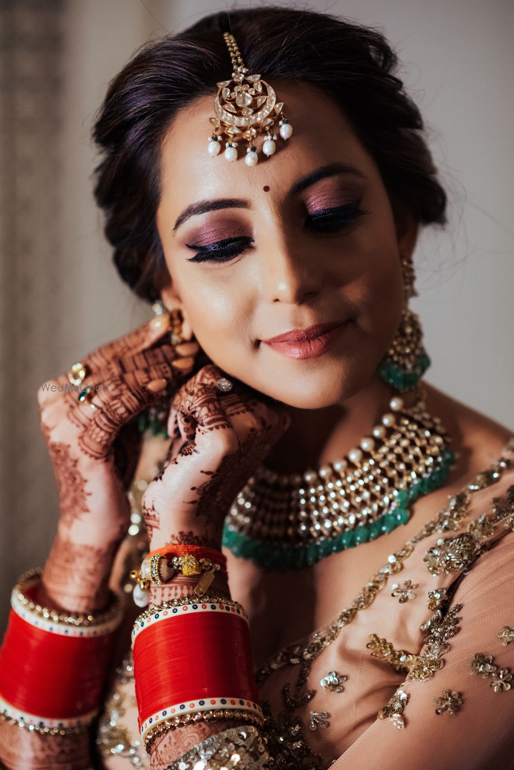 Photo of Candid shot of a bride wearing her earrings.