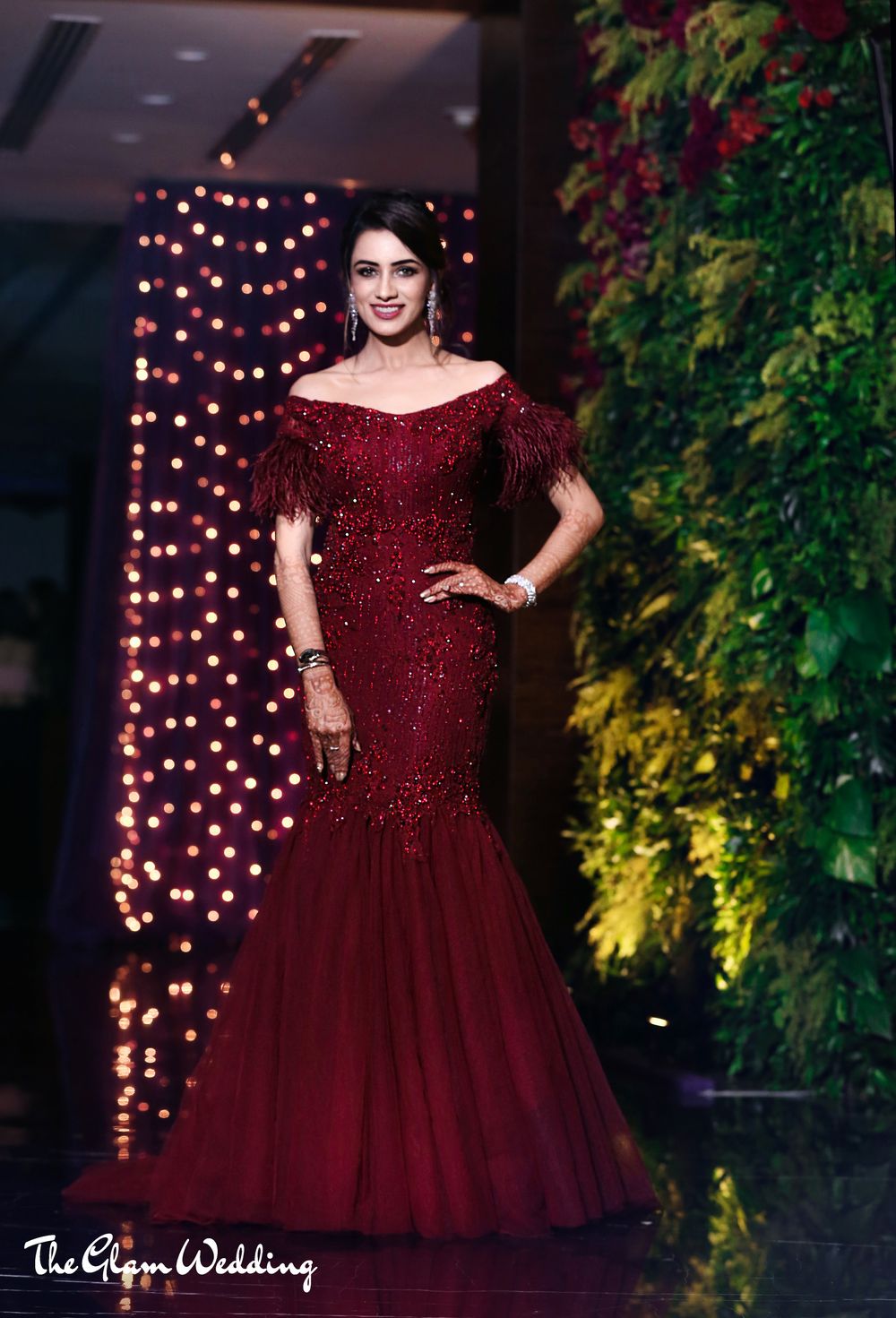 Photo of Winter wedding gown in deep maroon with fur sleeves