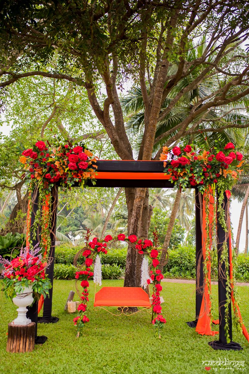 Photo of Mehendi swing decor with red roses