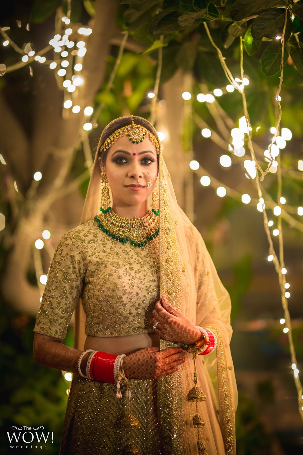 Photo of Bride in gold with green jewellery