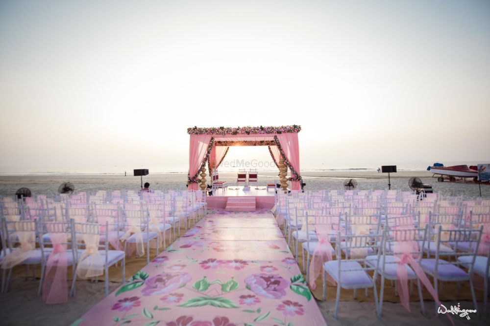 Photo of Beach wedding decor with floral printed aisle