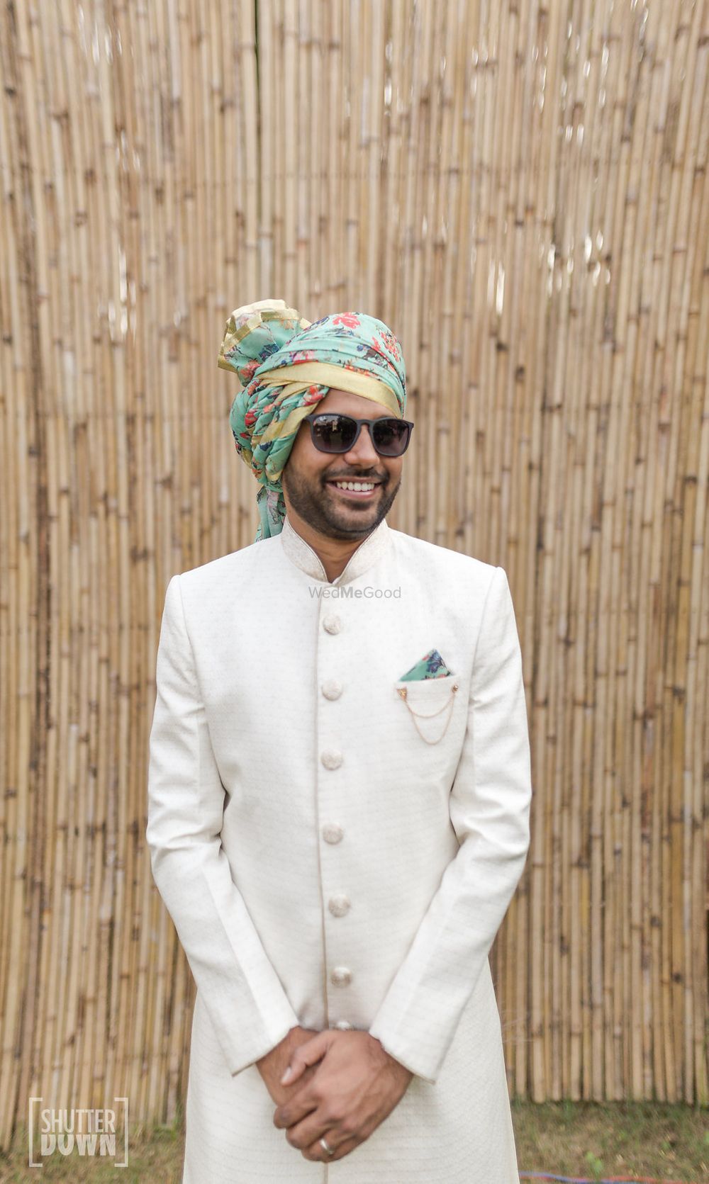 Photo of Contrasting groom accessories with white sherwani