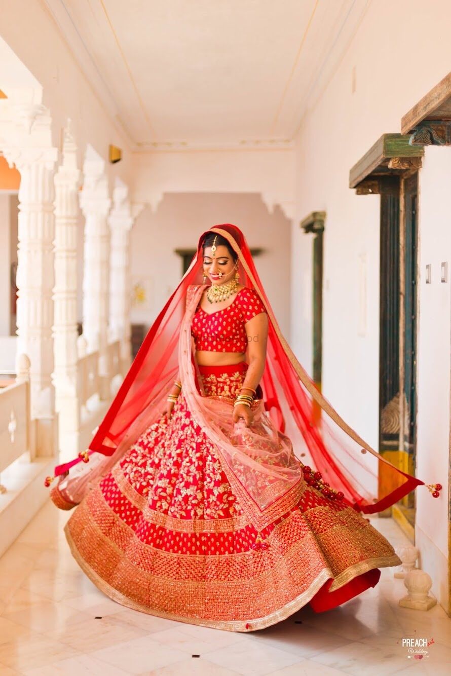 Photo of Simple red bridal lehenga twirling bride