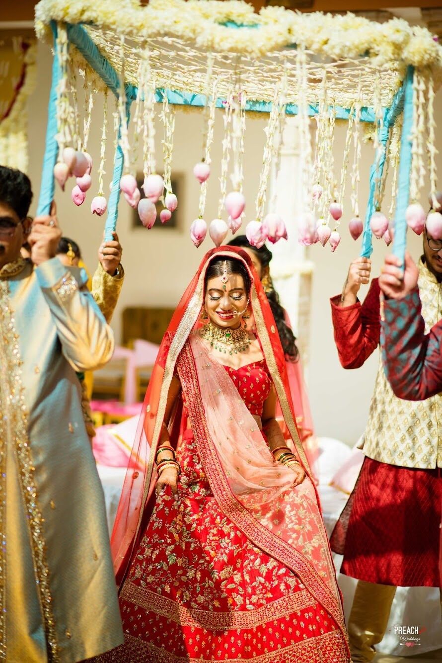 Photo of Bride entering under phoolon ki chadar with lotus and floral strings