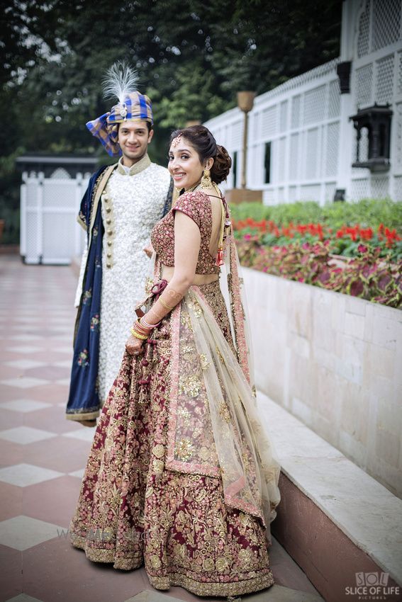 Photo of Maroon and gold bridal lehenga with zardozdi work