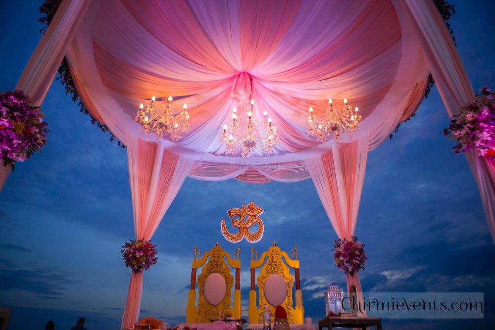 Photo of Bright and light pink mandap with chandeliers