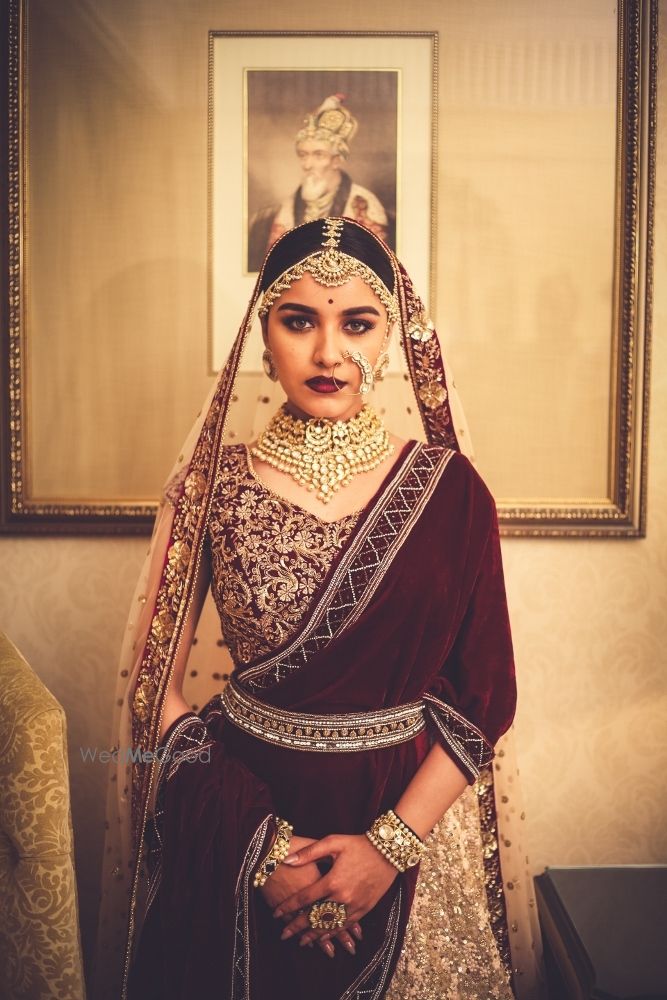 Photo of Velvet maroon bridal lehenga with waist belt