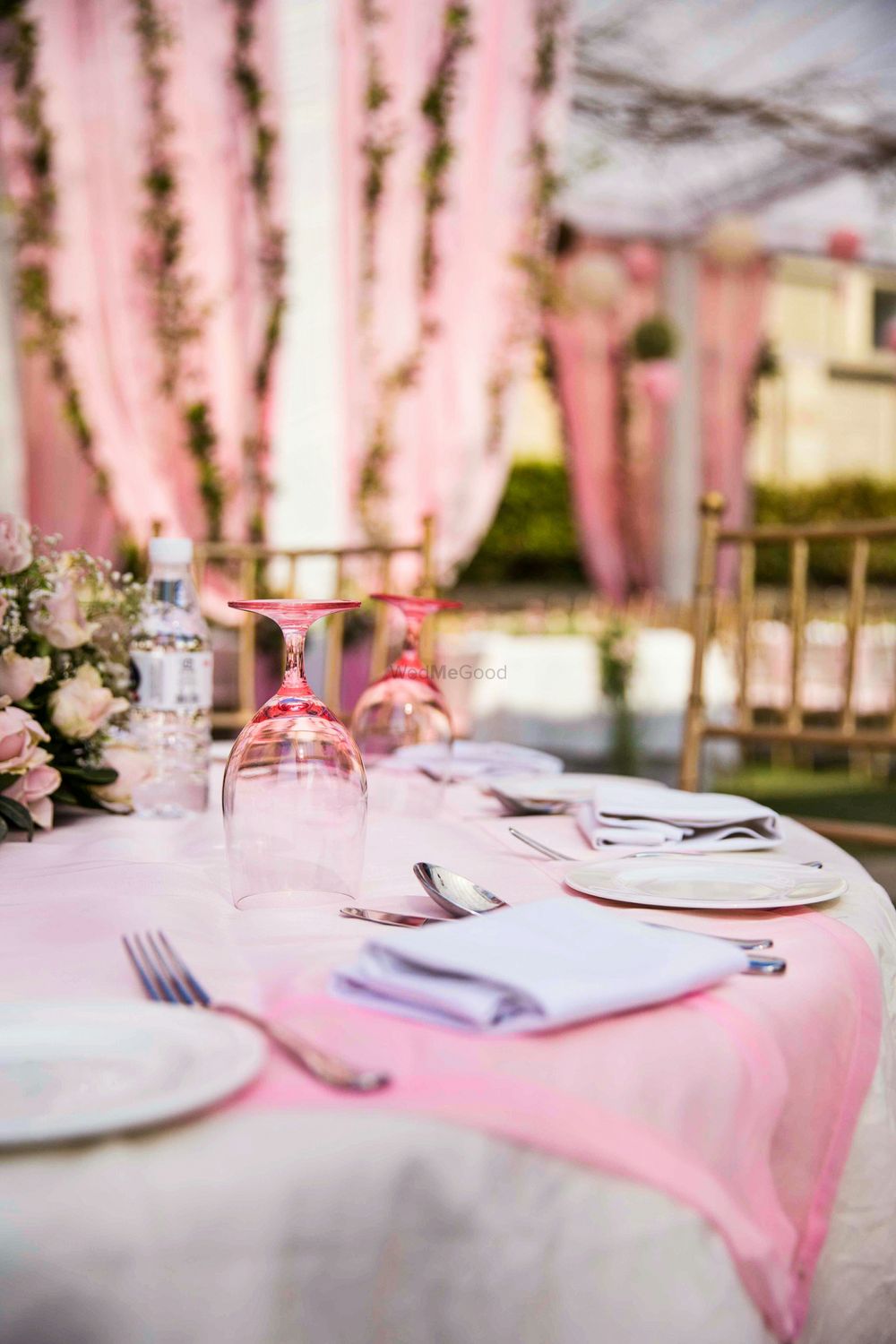 Photo of Stunning pink and white table settings with floral centerpieces