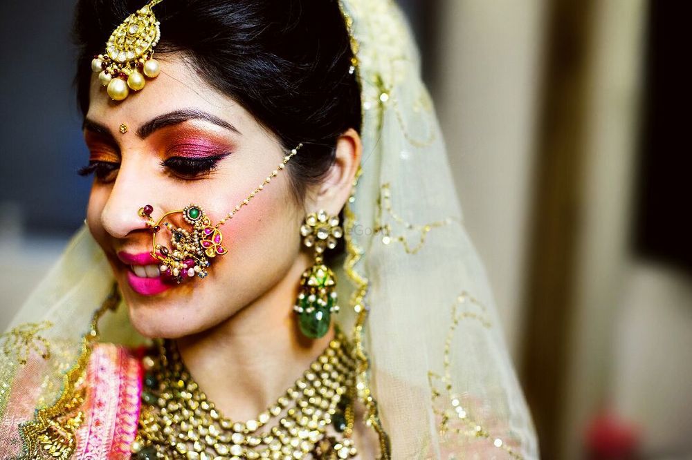 Photo of Unique bridal Nath with green stones