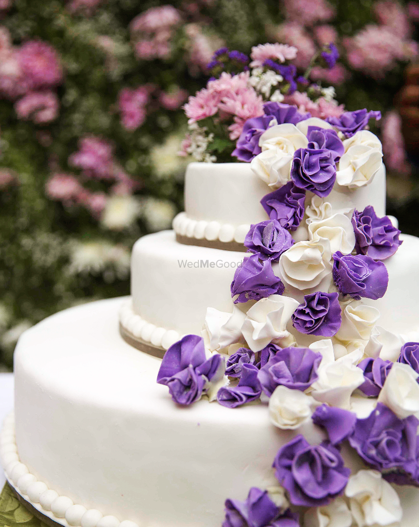 Photo of 3 tier purple and white floral cake