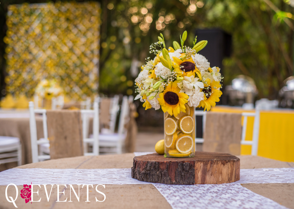 Photo of Stunning sunflower themed table centerpieces with fruits in vases