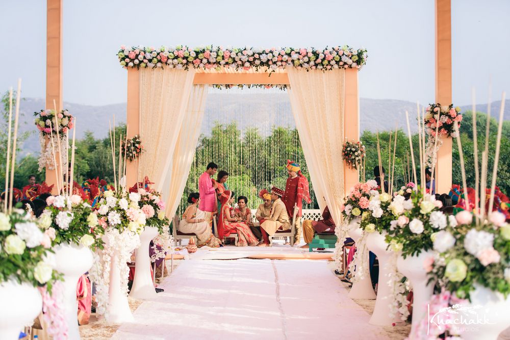 Photo of Beautiful mandap set up with floral against mountain scenery