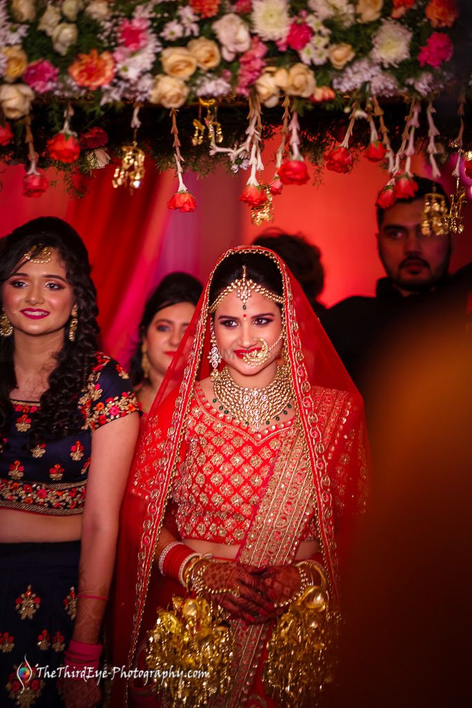 Photo of Bride in red under roses phoolon ka chadar