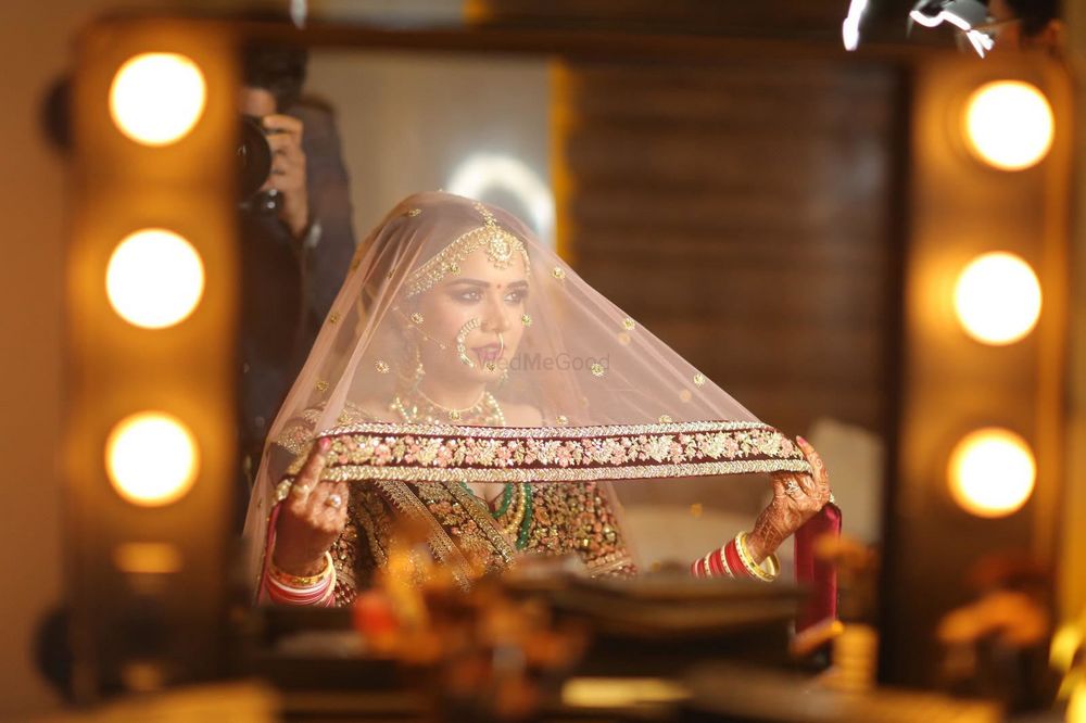 Photo of Bridal portrait holding dupatta as veil