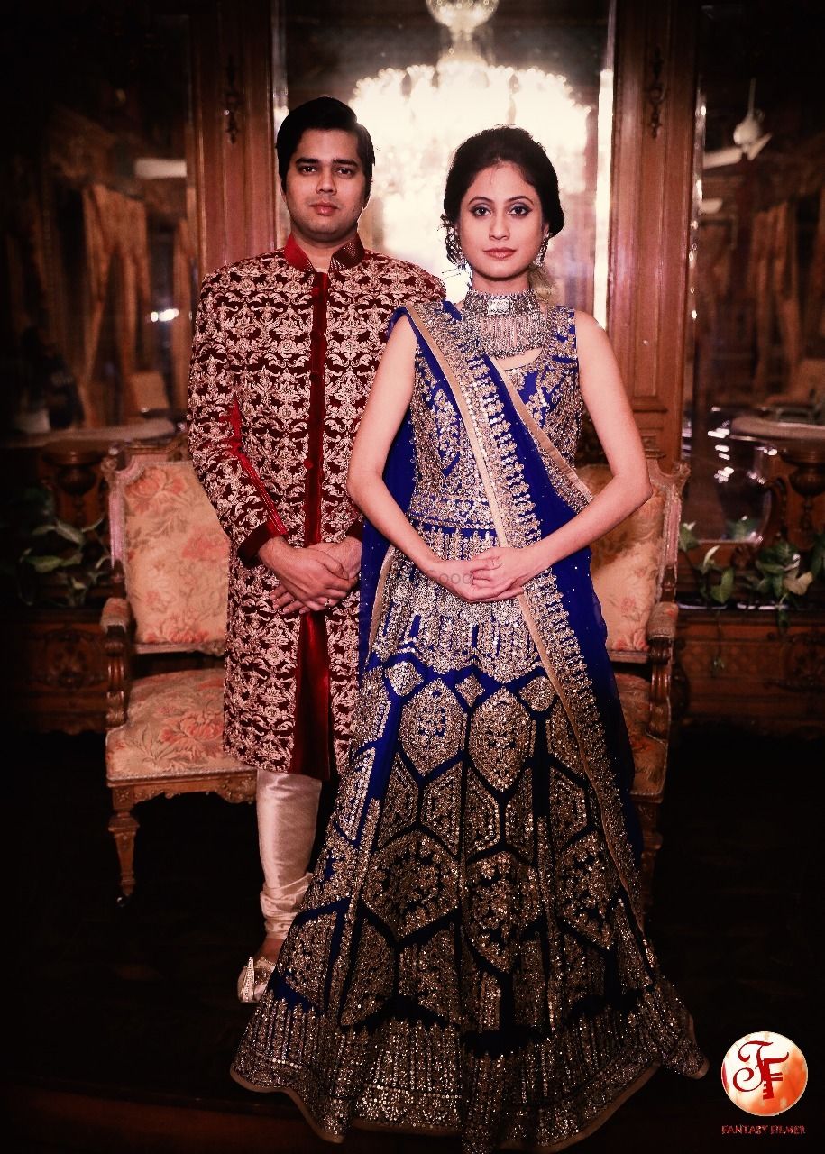 Photo of Beautiful royal blue lehenga with work all over and groom in maroon sherwani