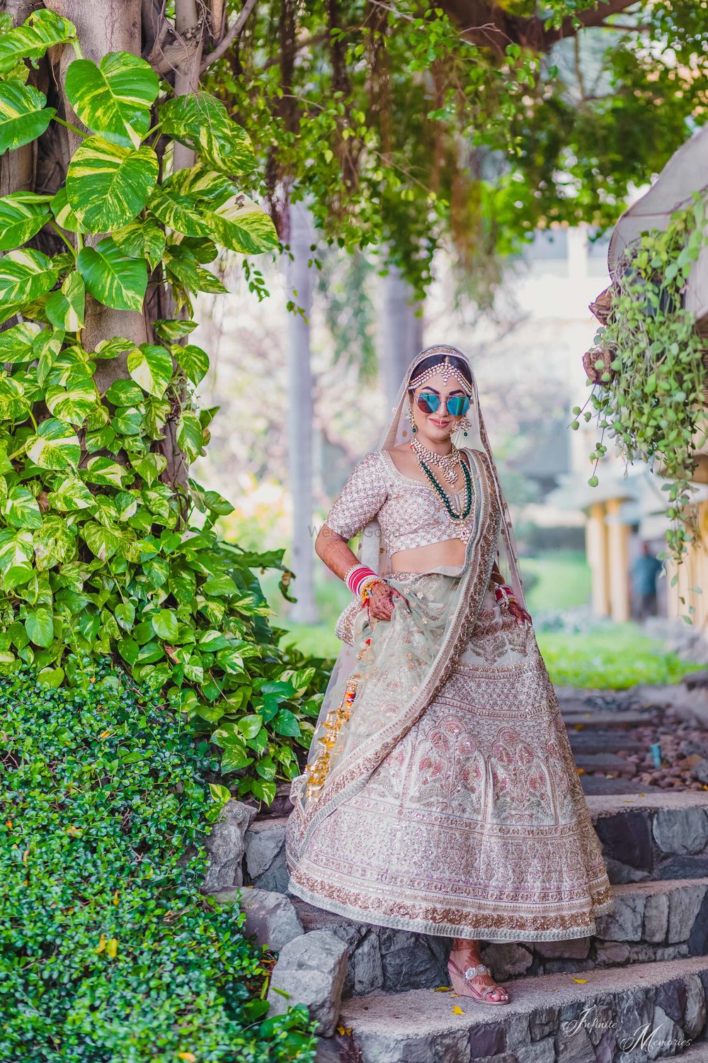 Photo of Bride in off white bridal lehenga and reflectors