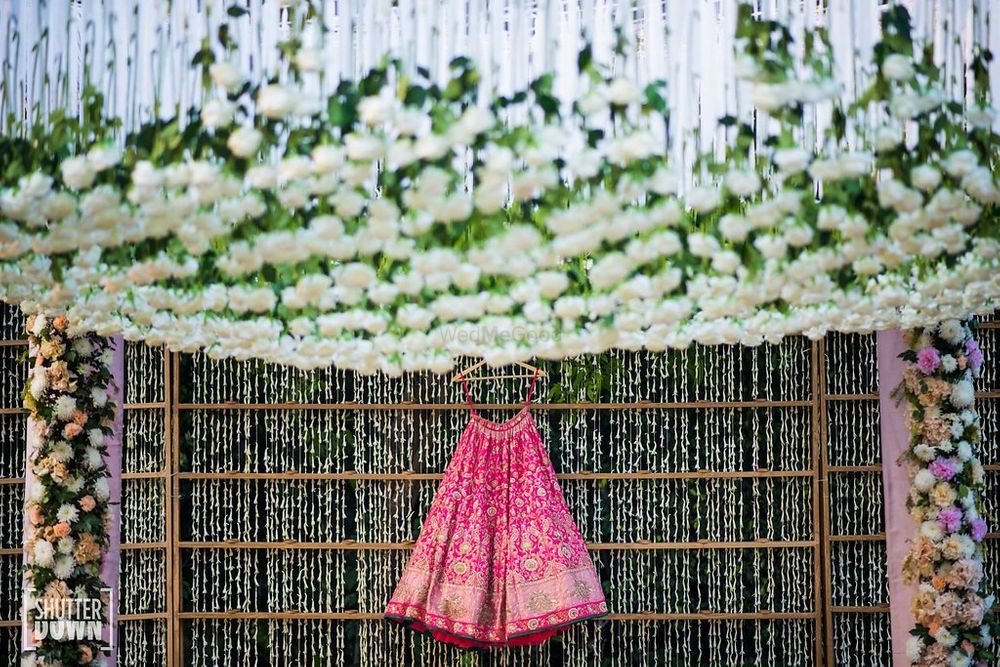 Photo of Bright pink bridal benarasi lehenga on hanger