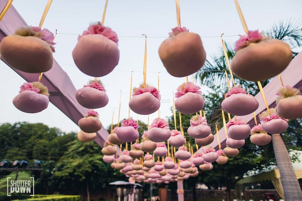 Photo of Unique hanging decor elements with suspended potlis