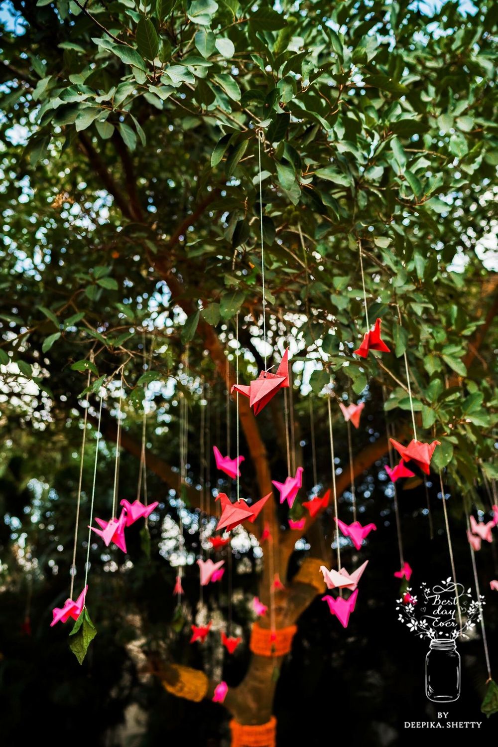Photo of Colourful origami birds hanging from a tree decor
