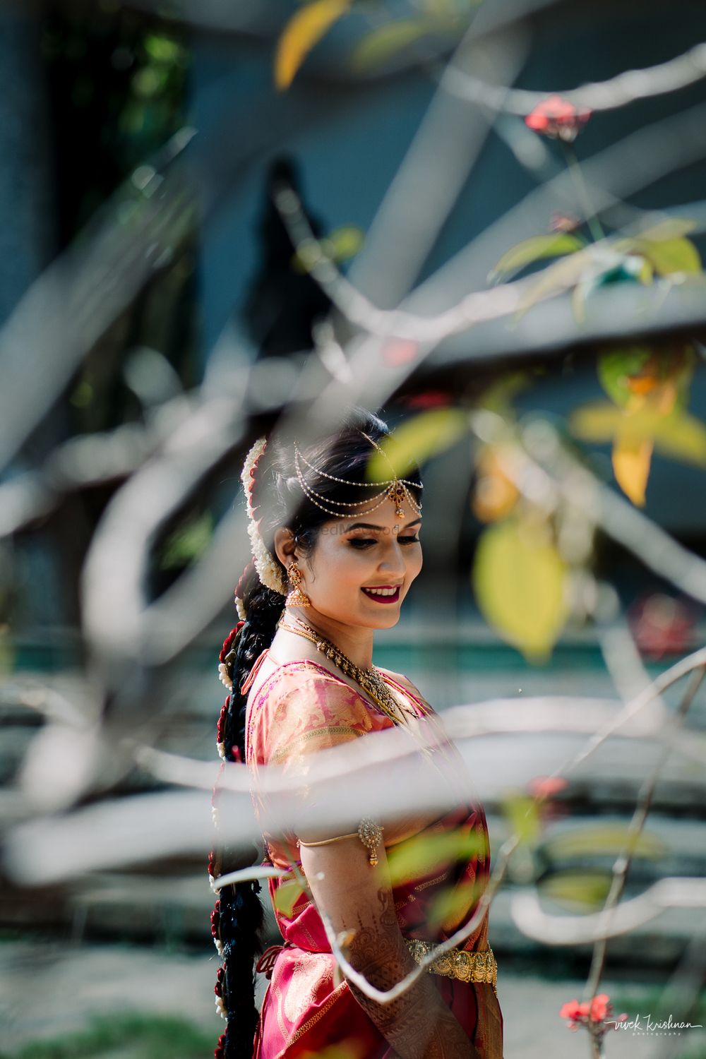 Photo of South Indian bridal portrait through tree
