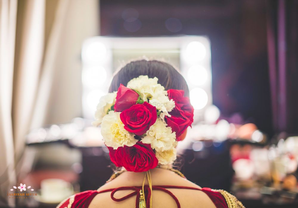 Photo of Beautiful bridal bun with red roses and white carnations