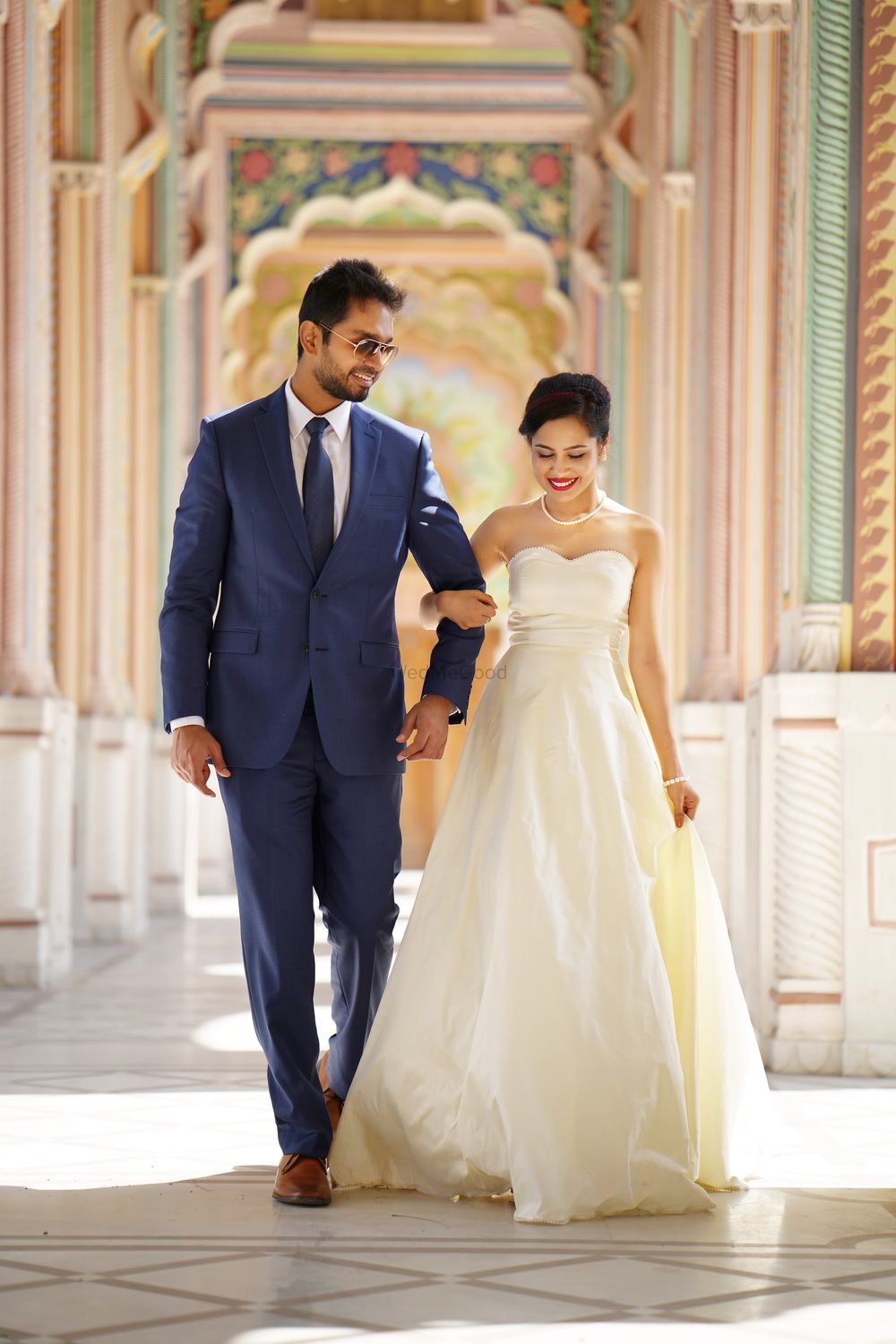 Photo of Beautiful outdoor couple shot with bride in sweetheart neckline gown and groom in royal blue suit