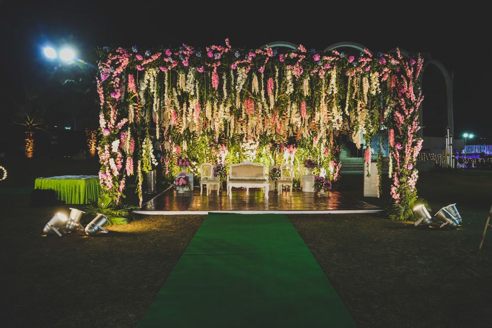 Photo of Stunning outdoor decor stage with pink and white florals