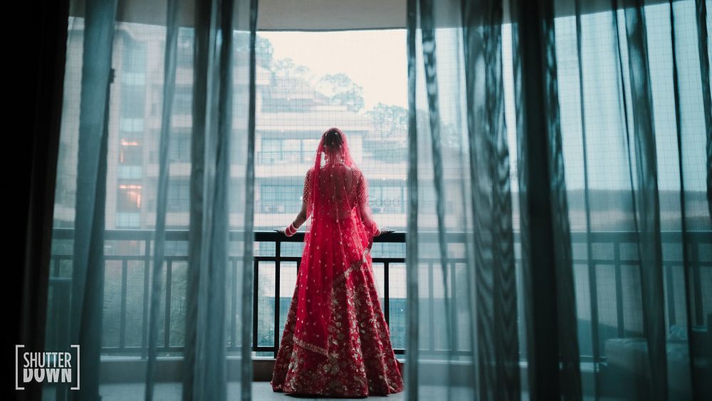 Photo of Bridal portrait idea looking out of balcony