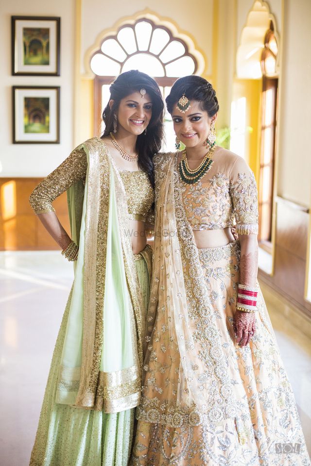 Photo of Bride and sister in girly pastel lehengas