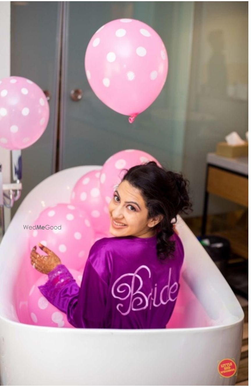 Photo of Bride in bathtub and purple robe