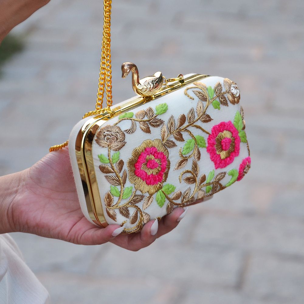 Photo of white pink and green clutch