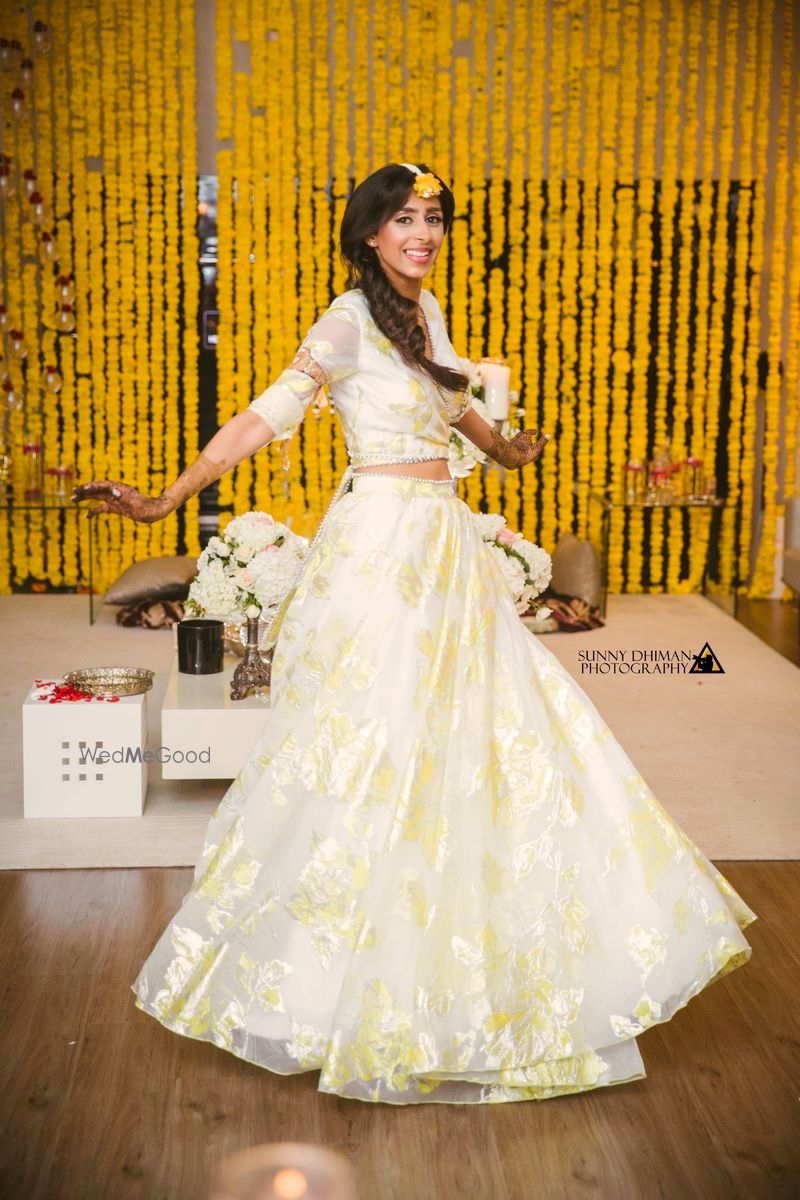 Photo of Bride twirling in simple off white organza lehenga