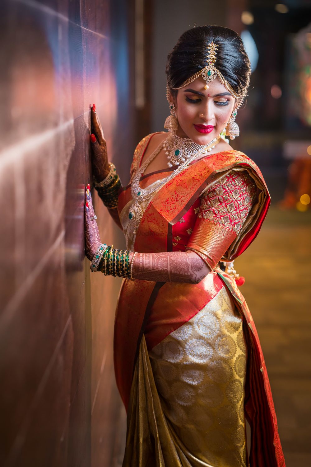 Photo of South Indian bridal look in gold kanjivaram with orange