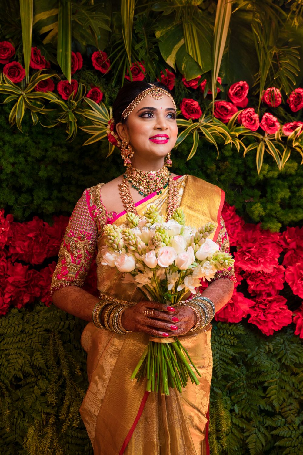 Photo of South Indian bridal look holding bouquet