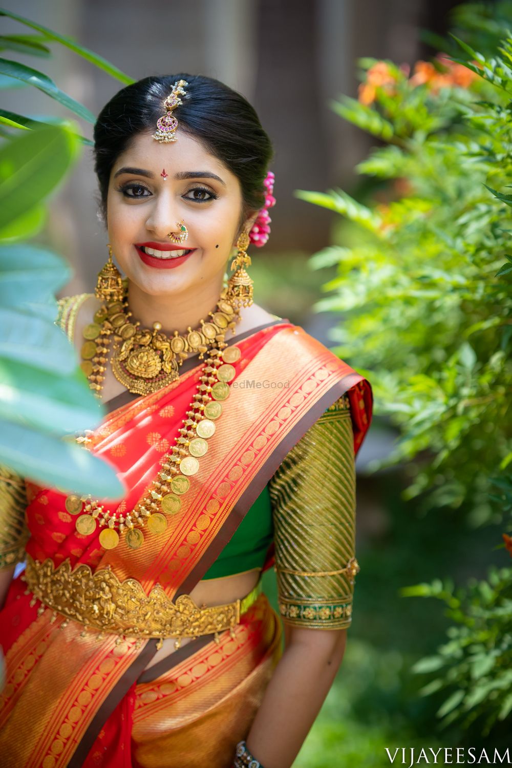 Photo of A south Indian bride wearing a kanjeevaram saree and gold, temple jewelry