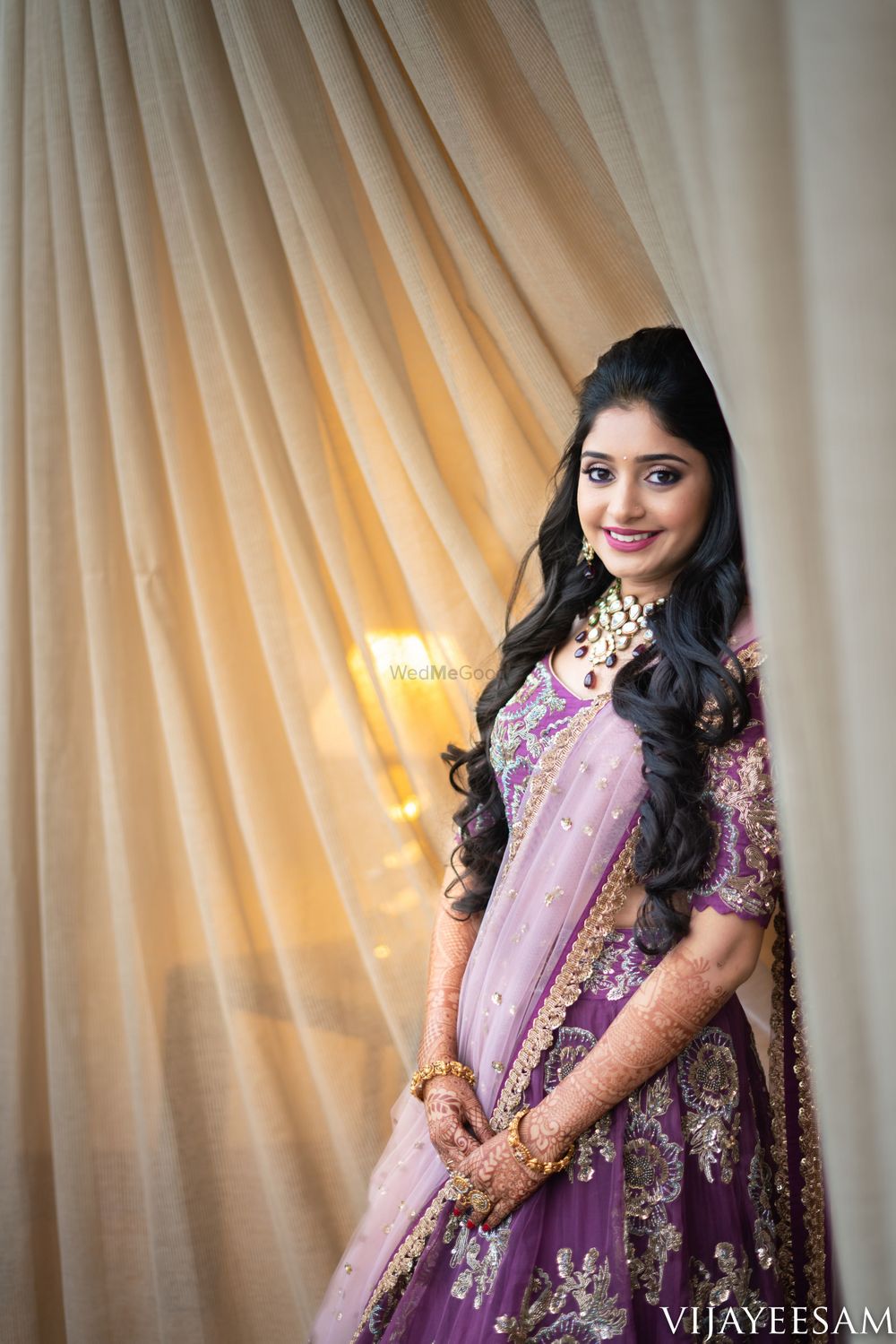 Photo of Sangeet bridal look with open hair and purple lehenga