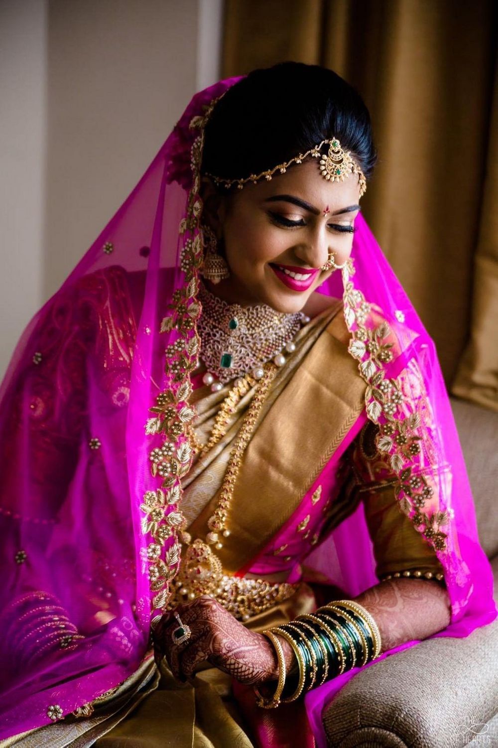 Photo of South Indian bride in gold saree with pink dupatta