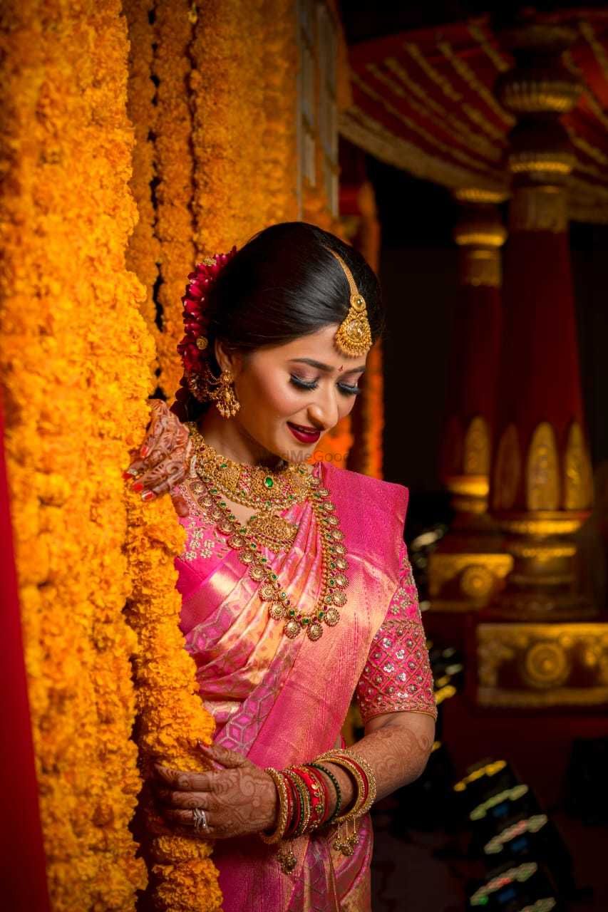 Photo of south indian bridal look with pink saree and layered jewellery