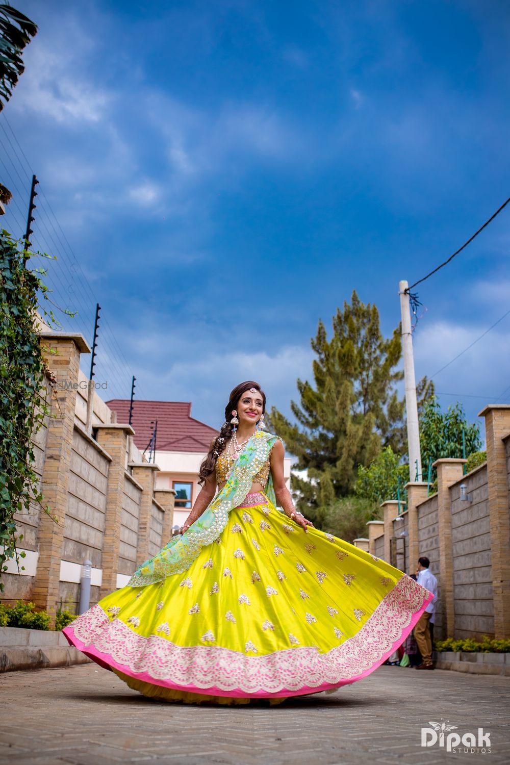 Photo of Bride showing off colourful mehendi lehenga