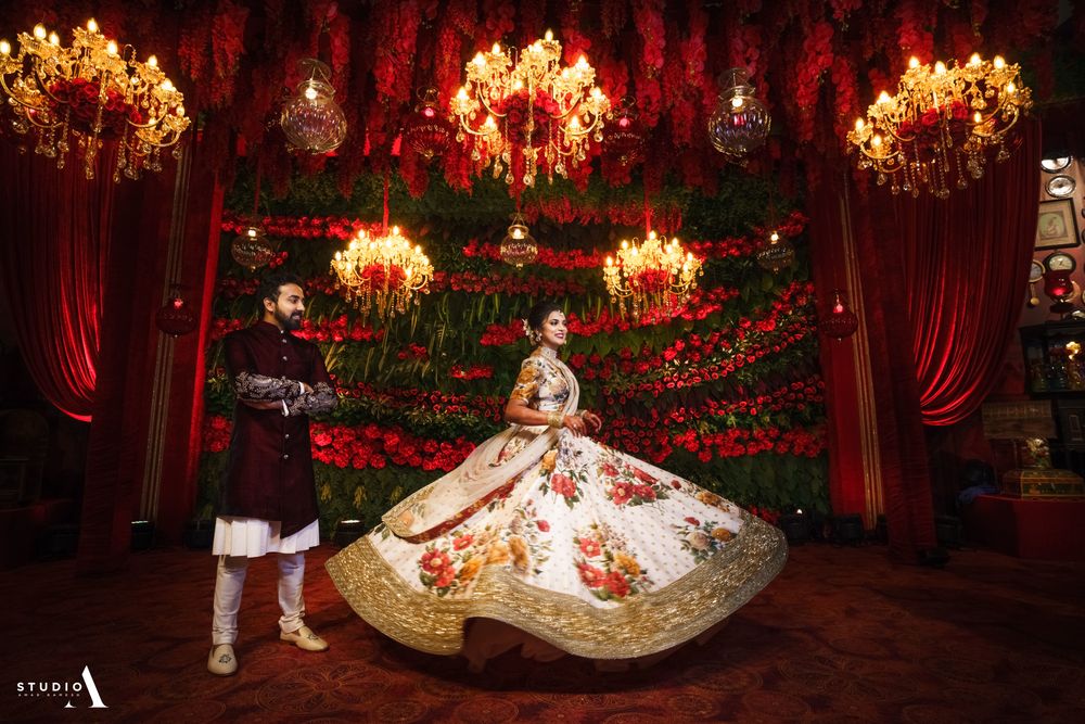 Photo of Twirling bride in floral Sabyasachi lehenga